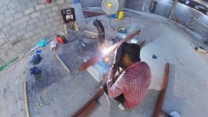 Man welding the 3" GI pipe for chilled water system AC