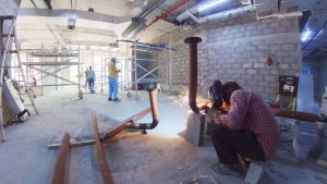 Man welding the 3" GI pipe for chilled water system AC