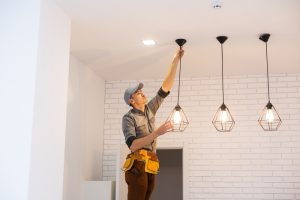 Image of a professional installing lights in a room.